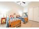 Bedroom featuring two twin beds, closet with sliding doors, and a ceiling fan at 19727 E Julius Rd, Queen Creek, AZ 85142