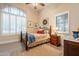 Comfortable bedroom featuring a ceiling fan, shuttered windows, and neutral color palette at 19727 E Julius Rd, Queen Creek, AZ 85142