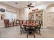 Charming dining area with elegant table setting, decorative shelving, and ample natural light at 19727 E Julius Rd, Queen Creek, AZ 85142