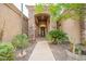 Exterior stone archway at home's entrance, leading to a decorative front door at 19727 E Julius Rd, Queen Creek, AZ 85142