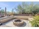 Inviting outdoor fire pit with built-in seating and mature desert landscaping at 19727 E Julius Rd, Queen Creek, AZ 85142