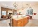 Bright and spacious kitchen featuring an island, pendant lighting, and an adjacent dining area at 19727 E Julius Rd, Queen Creek, AZ 85142