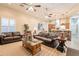 Open-concept living space with leather furniture and an island with stone accents at 19727 E Julius Rd, Queen Creek, AZ 85142