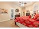 A corner view of the primary bedroom suite that includes a king bed and a sitting area at 19727 E Julius Rd, Queen Creek, AZ 85142