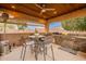 Spacious outdoor kitchen with a built-in grill, countertop space, and a ceiling fan for the covered patio at 19727 E Julius Rd, Queen Creek, AZ 85142