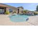 Sparkling pool with rock waterfall feature and manicured landscaping creates a private outdoor oasis at 19727 E Julius Rd, Queen Creek, AZ 85142