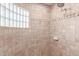 Tiled shower stall with glass-block window for natural light at 19927 W Meadowbrook Ave, Litchfield Park, AZ 85340