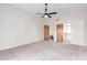 Bright bedroom with neutral carpet and ceiling fan, with access to an ensuite bathroom at 19927 W Meadowbrook Ave, Litchfield Park, AZ 85340