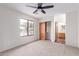 Bedroom featuring natural light, neutral carpet, and access to ensuite bathroom and closet at 19927 W Meadowbrook Ave, Litchfield Park, AZ 85340