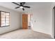 Bedroom with neutral carpet, a window, and a solid wood door to another room at 19927 W Meadowbrook Ave, Litchfield Park, AZ 85340