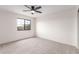 Well lit bedroom features neutral carpet and a window offering outdoor views at 19927 W Meadowbrook Ave, Litchfield Park, AZ 85340