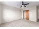 Bright bedroom with ceiling fan and closet featuring a solid wood door at 19927 W Meadowbrook Ave, Litchfield Park, AZ 85340