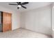 Bedroom featuring neutral carpet and a closet with a unique solid wood door at 19927 W Meadowbrook Ave, Litchfield Park, AZ 85340