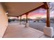 Spacious covered patio with wooden support beams offers a serene outdoor living space at 19927 W Meadowbrook Ave, Litchfield Park, AZ 85340