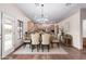 Elegant dining room featuring a wood table, complementary decor, and access to the kitchen at 19927 W Meadowbrook Ave, Litchfield Park, AZ 85340