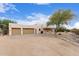 Spacious 3-car garage with a large driveway and desert landscaping, providing ample parking for vehicles at 19927 W Meadowbrook Ave, Litchfield Park, AZ 85340