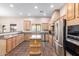 Bright kitchen features stainless steel appliances, granite countertops, and a functional island at 19927 W Meadowbrook Ave, Litchfield Park, AZ 85340