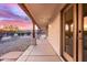 Covered patio with desert views framed by wooden support beams and tiled floors at 19927 W Meadowbrook Ave, Litchfield Park, AZ 85340