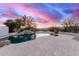 Backyard oasis featuring a pool, rock waterfall, and desert landscaping at 19927 W Meadowbrook Ave, Litchfield Park, AZ 85340