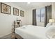 Bright bedroom with natural light, ceiling fan, decor and crisp white linens at 20477 N 91St Dr, Peoria, AZ 85382