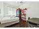 Bright bedroom featuring stylish decor, laminate floors, and a window for natural light at 20477 N 91St Dr, Peoria, AZ 85382
