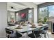 Dining room with modern table and chairs, open to living area and natural light at 20477 N 91St Dr, Peoria, AZ 85382