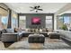 Comfortable living area with sectional sofa, ottoman, and large windows at 20477 N 91St Dr, Peoria, AZ 85382