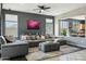 Spacious living area with large sectional sofa and view into adjacent kitchen at 20477 N 91St Dr, Peoria, AZ 85382