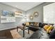 Comfortable living room with dark leather sofa, area rug, and modern decor at 20477 N 91St Dr, Peoria, AZ 85382