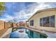 Sparkling pool with lounging area, brick perimeter walls, and desert landscaping at 20477 N 91St Dr, Peoria, AZ 85382