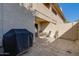 View of the backyard patio featuring outdoor seating, textured walls, and a partial view of the home's exterior at 2142 E Turney Ave # 4, Phoenix, AZ 85016