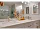 Bathroom featuring dual sinks with white vanities, quartz countertops, modern lighting, and updated shower at 2142 E Turney Ave # 4, Phoenix, AZ 85016