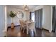 Bright dining room featuring wood-like floors, modern light fixture, and large round decorative mirror at 2142 E Turney Ave # 4, Phoenix, AZ 85016