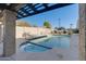 Community pool and hot tub with crystal clear water, lounge chairs, and shade structure at 2142 E Turney Ave # 4, Phoenix, AZ 85016