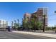 Exterior shot of Phoenix Towers with a light rail train and palm trees in view at 2201 N Central Ave # 2A, Phoenix, AZ 85004