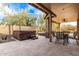 Outdoor patio featuring a spa, fire pit, dining area, and scenic desert landscaping at 22905 N 19Th Way, Phoenix, AZ 85024