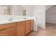 Bathroom featuring a double sink vanity and a walk-in shower with tile surround at 22905 N 19Th Way, Phoenix, AZ 85024