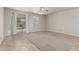 This is a bright bedroom featuring plush carpeting, a ceiling fan, and sliding glass door access to the patio at 22905 N 19Th Way, Phoenix, AZ 85024