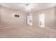 Large bedroom with ceiling fan, view of kitchen, and bracketed television at 22905 N 19Th Way, Phoenix, AZ 85024