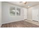 Bright bedroom with wood-look flooring, ceiling fan, and a large window at 22905 N 19Th Way, Phoenix, AZ 85024