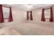 Spacious bedroom with multiple windows, plush carpet, ceiling fan, and neutral walls at 22905 N 19Th Way, Phoenix, AZ 85024