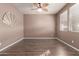 Empty bedroom with wood floors, ceiling fan, and a decorative mirror at 22905 N 19Th Way, Phoenix, AZ 85024