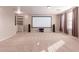 Large bonus room with a built-in bookshelf and screen, perfect for entertainment at 22905 N 19Th Way, Phoenix, AZ 85024