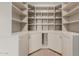 Walk-in closet with wrap around shelving and storage cabinets at 22905 N 19Th Way, Phoenix, AZ 85024