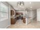 Open kitchen features stainless steel appliances, an island, and sleek brown cabinetry at 22905 N 19Th Way, Phoenix, AZ 85024