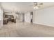 Open-concept living area with kitchen view, carpeted space, and natural light at 22905 N 19Th Way, Phoenix, AZ 85024