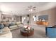 Staged living room featuring a cozy sofa, coffee table, and nearby kitchen at 22905 N 19Th Way, Phoenix, AZ 85024