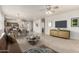 Open-concept living room with a dining area and kitchen, showcasing modern furnishings and neutral tones at 22905 N 19Th Way, Phoenix, AZ 85024