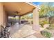 Expansive covered patio with ceiling fan, hot tub, fire pit, and well-manicured landscaping at 22905 N 19Th Way, Phoenix, AZ 85024