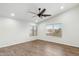 Bright bedroom with neutral walls, hardwood floors, a ceiling fan, and natural light from two windows at 2472 W Hawks Eye Ave, Apache Junction, AZ 85120